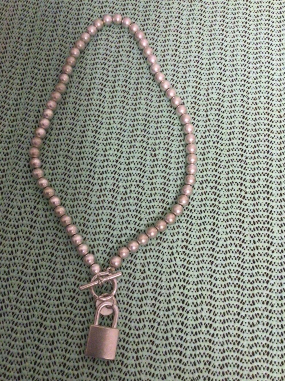 Bella canvas  silver paean necklace with lock pendant
